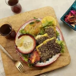 a plate of Za’atar Baked Fish on a wooden board