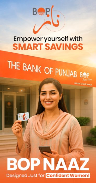 A women showing BOP NAZZ card in one hand and holding her mobile in her othe hand in front of The Bank of Punjab.